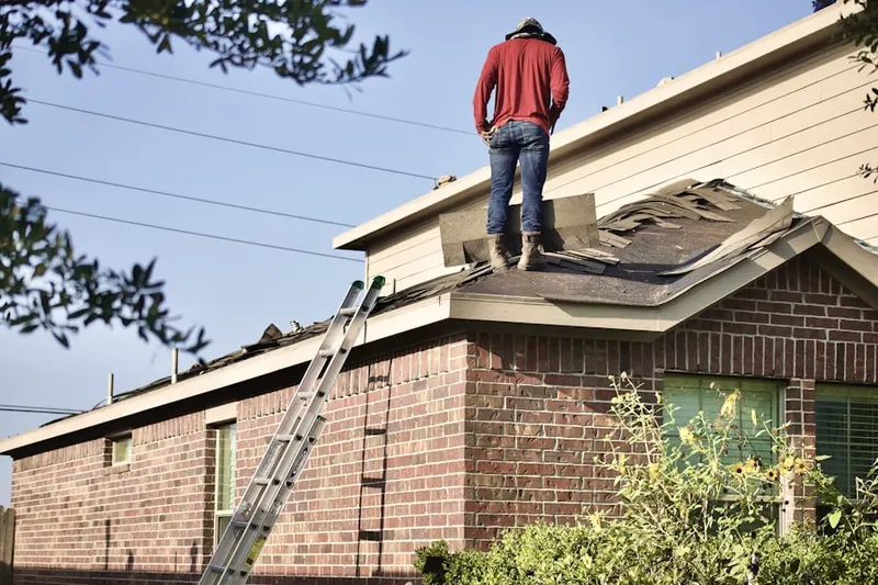 Professional roofer working on a residential roof in Cottage Grove